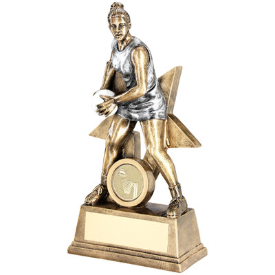 Superb gold & silver Netball player holding the ball in front of a star background available with FREE engraving 