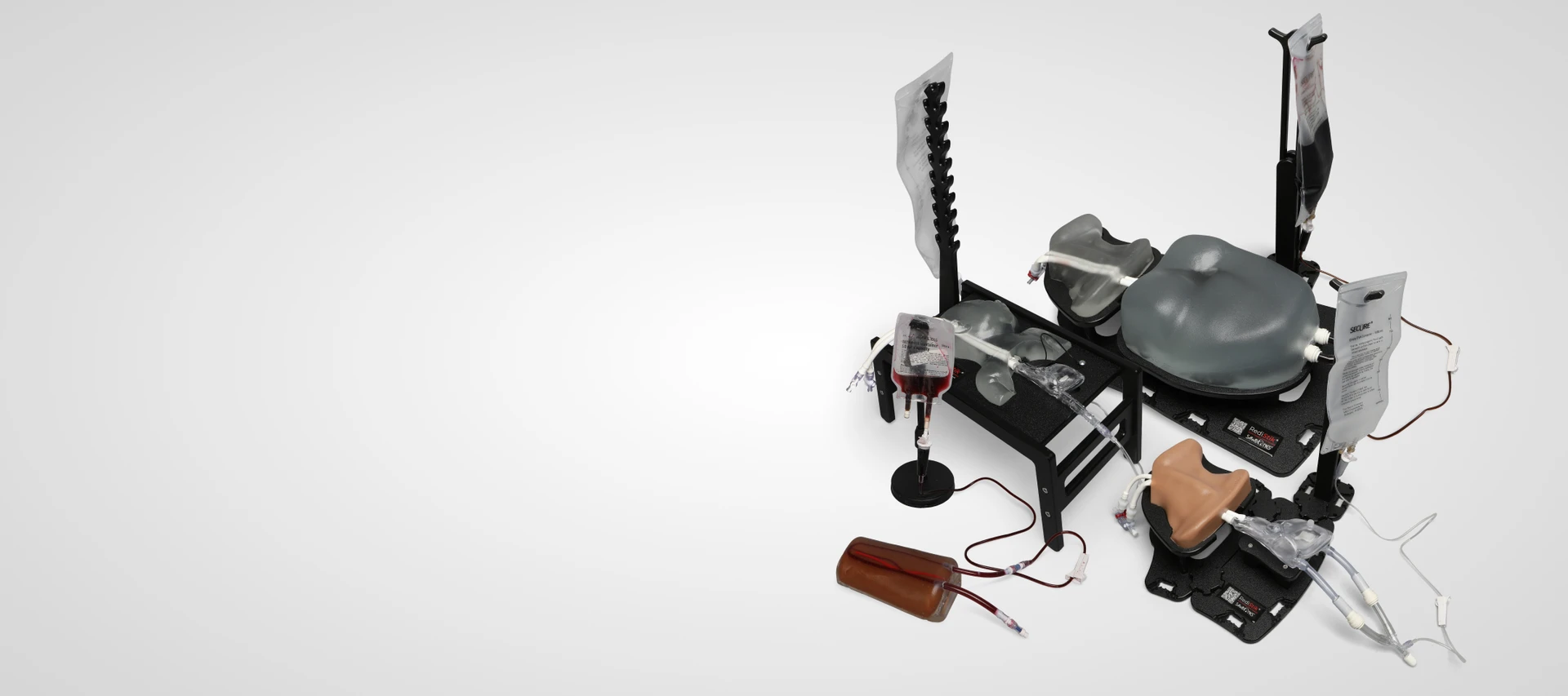 Sawbones ultrasound-guided vascular access trainer lineup, including neonatal, adult neck, chest, heart, and arm models with fluid bags and tubing.