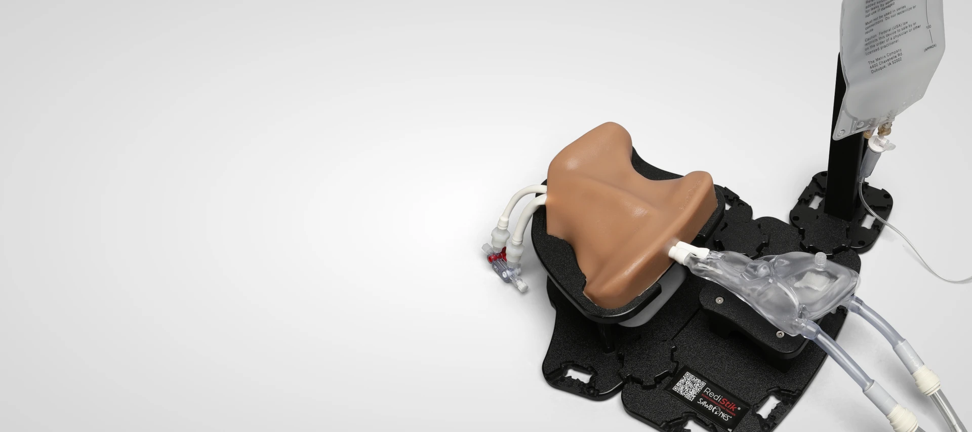 Sawbones adult IJV cannulation trainer connected to a clear heart model for ultrasound-guided central line and guidewire practice.