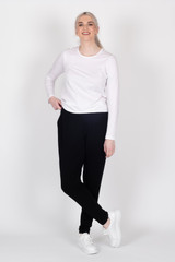 Tall woman in black Staple+Cloth Freida Pants with white Staple+Cloth Penny Tee