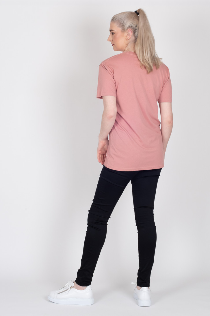 Tall woman showing back of Crossing The Lines Tee by Style X Lab