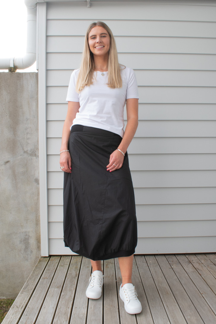 Tall woman wearing Frost Noir Skirt Black Front view