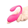 Together Ménage à Trois hot pink vibrating egg held in a hand to show compact wearable size and ribbed surface.