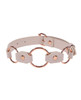 Close-up of the three rose gold rings on the Peaches ’n CreaMe peach faux-leather collar.