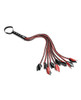 Close-up of the 9 braided red and black vegan faux leather falls on Sportsheets Saffron Flogger ending in small tips for precise stinging sensation during BDSM impact play