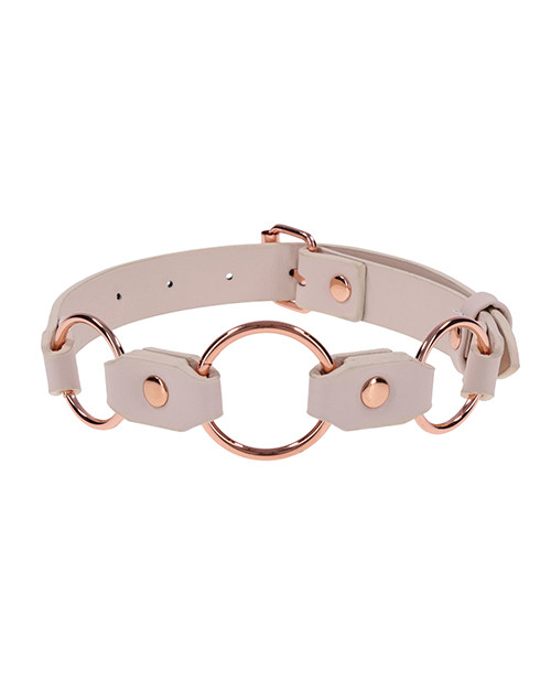 Close-up of the three rose gold rings on the Peaches ’n CreaMe peach faux-leather collar.